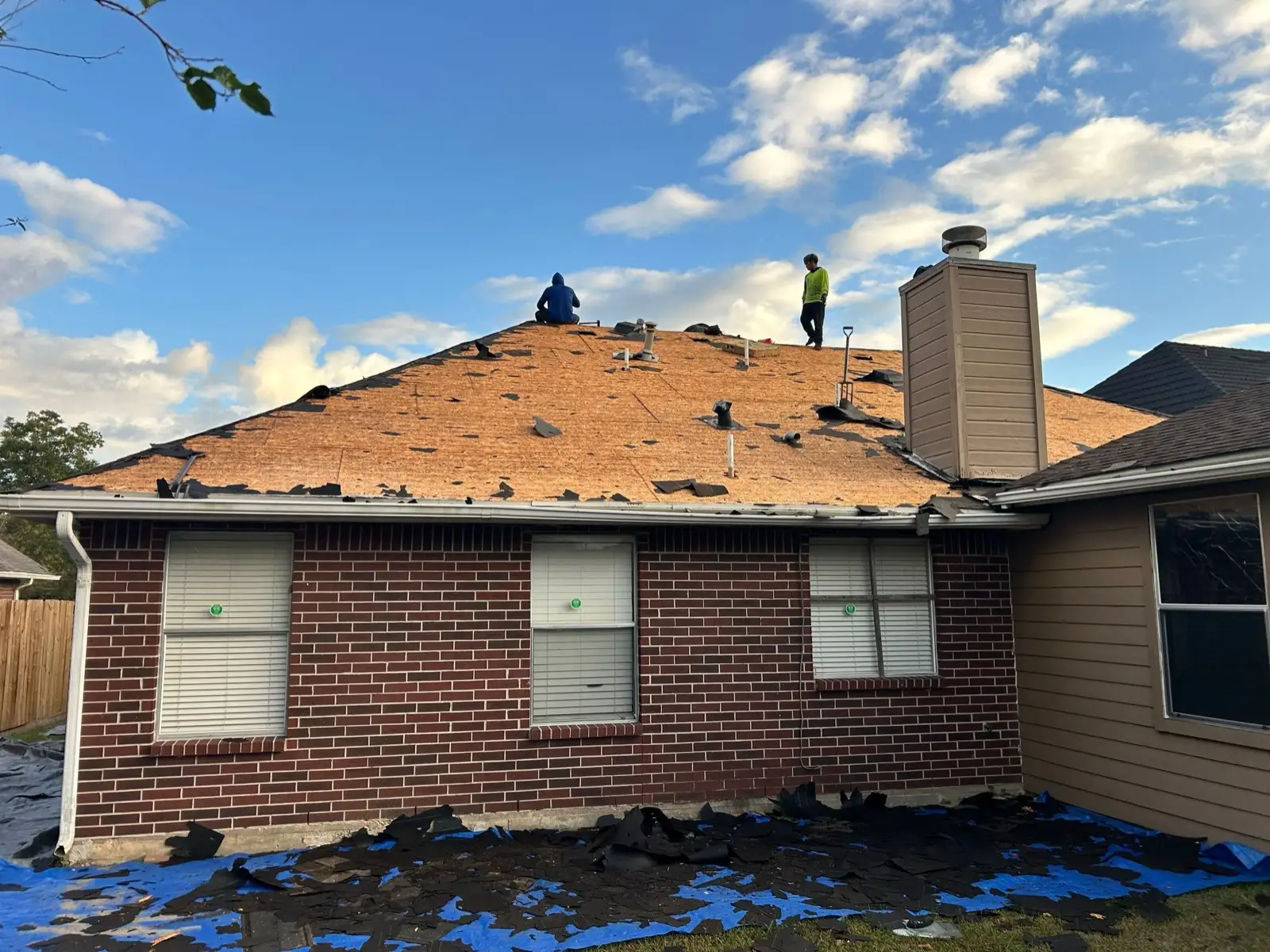 October 17. The back of the house at bare deck — every old shingle off before anything new went on.